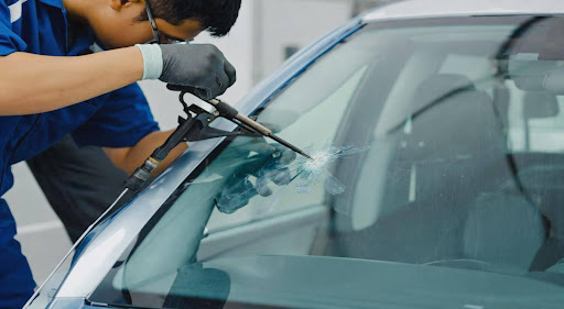 Coastal Auto Glass Repair technician repairing a windshield